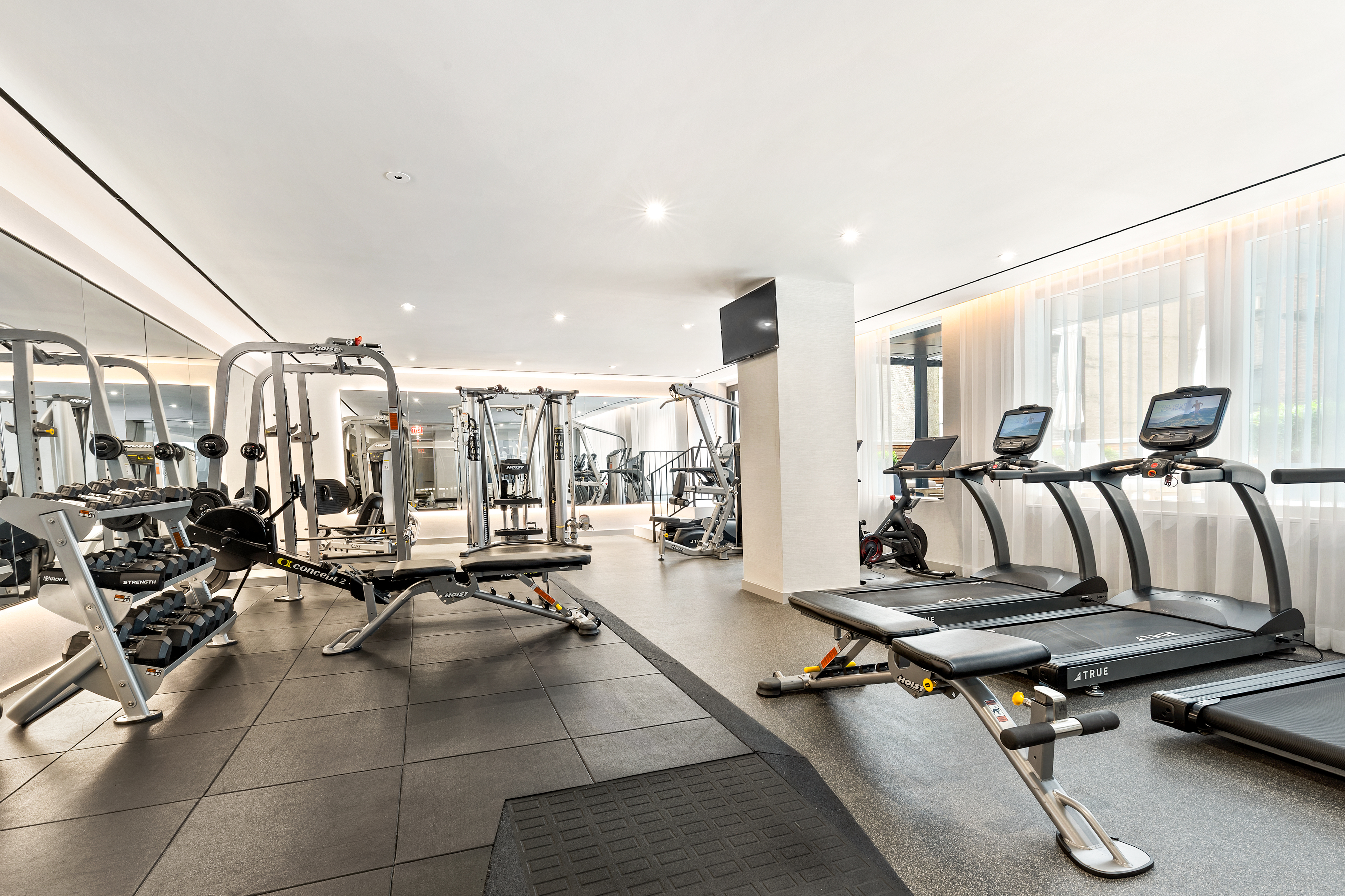 150 East 23rd Street, Unit 3C Manhattan, NY 10010 - Photo 10 of 12 a living room with lots of furniture and windows