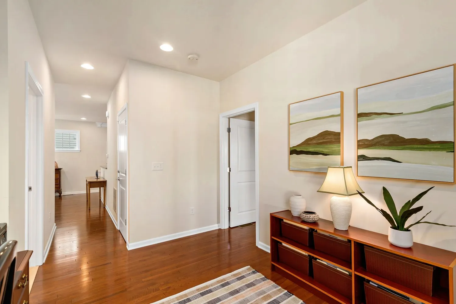a view of hallway with wooden floor