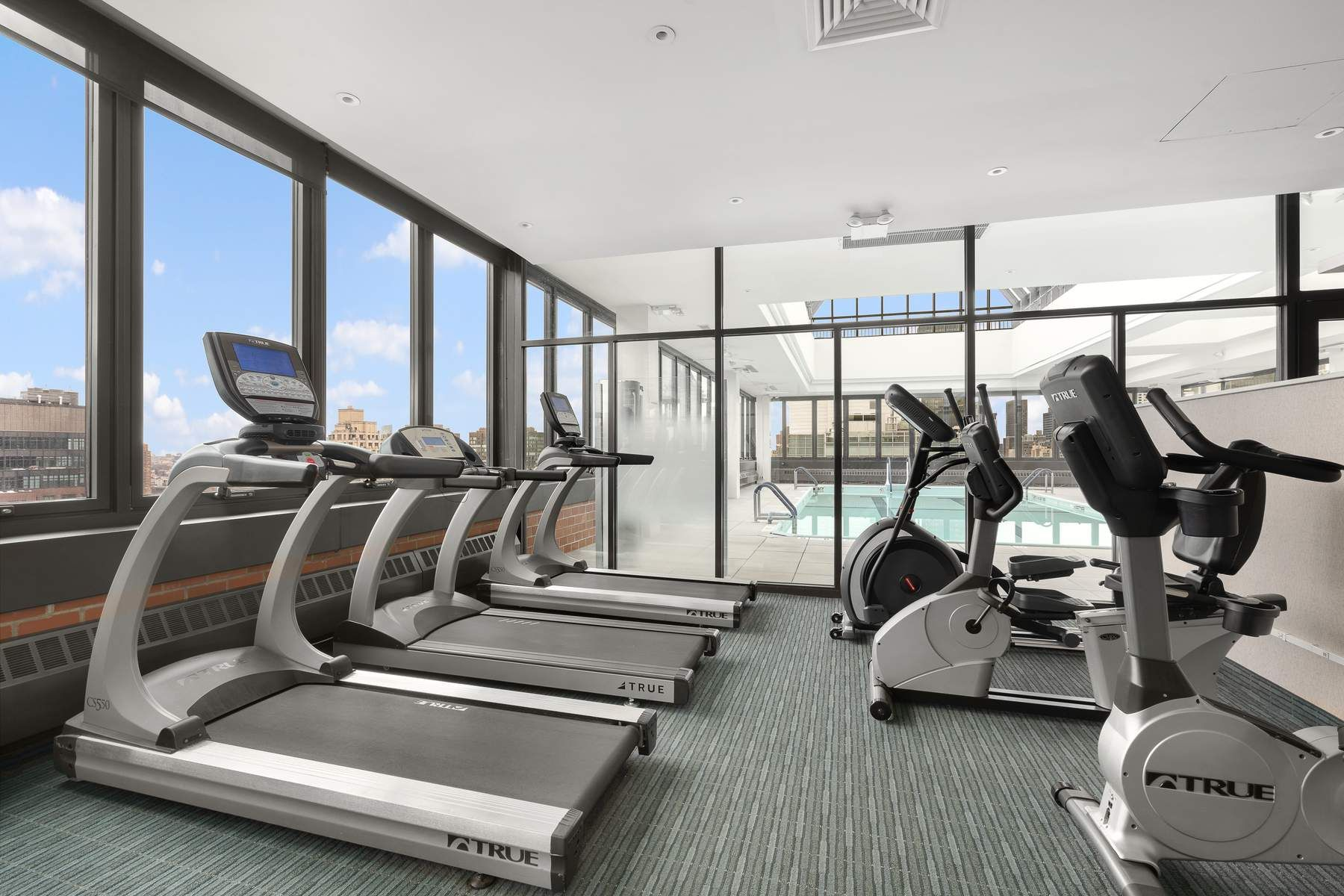 300 East 54th Street, Unit 23J Manhattan, NY 10022 - Photo 13 of 18 a view of a room with gym equipment