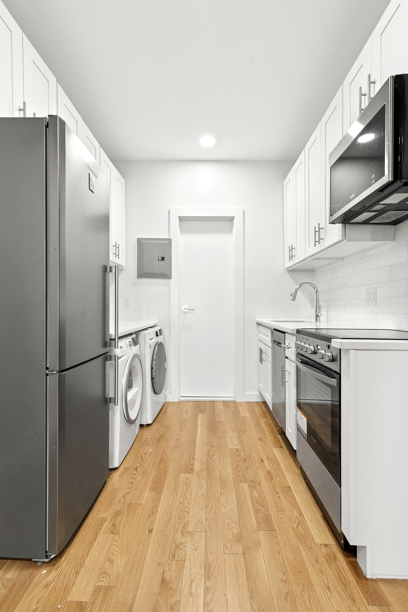 75 Pineapple Street, Unit 2A Brooklyn, NY 11201 - Photo 4 of 6 a kitchen with a refrigerator stove and microwave