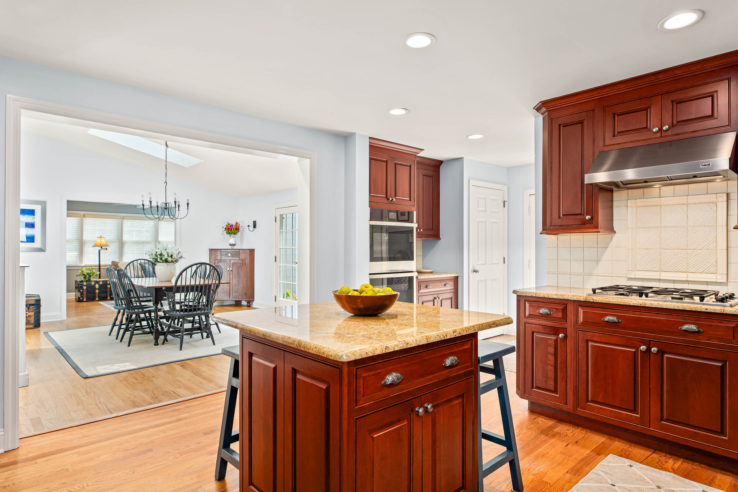 1136 Seaton Ross Road Wayne, PA 19087 - Photo 13 of 48 a kitchen with granite countertop cabinets a stove a dining table and chairs