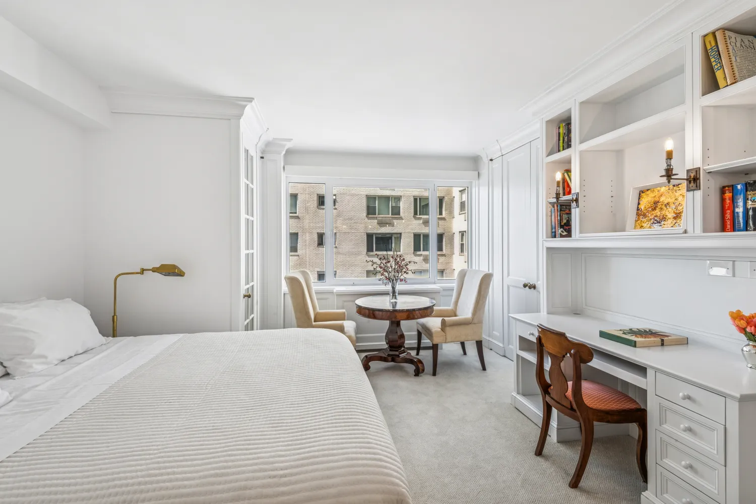 a bedroom with a bed and a desk