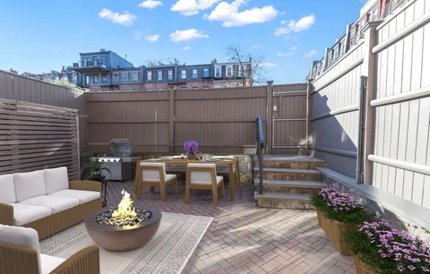 a view of a patio with couches table and chairs and potted plants