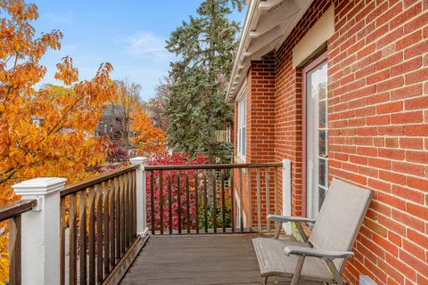 a view of balcony with wooden floor and outdoor seating