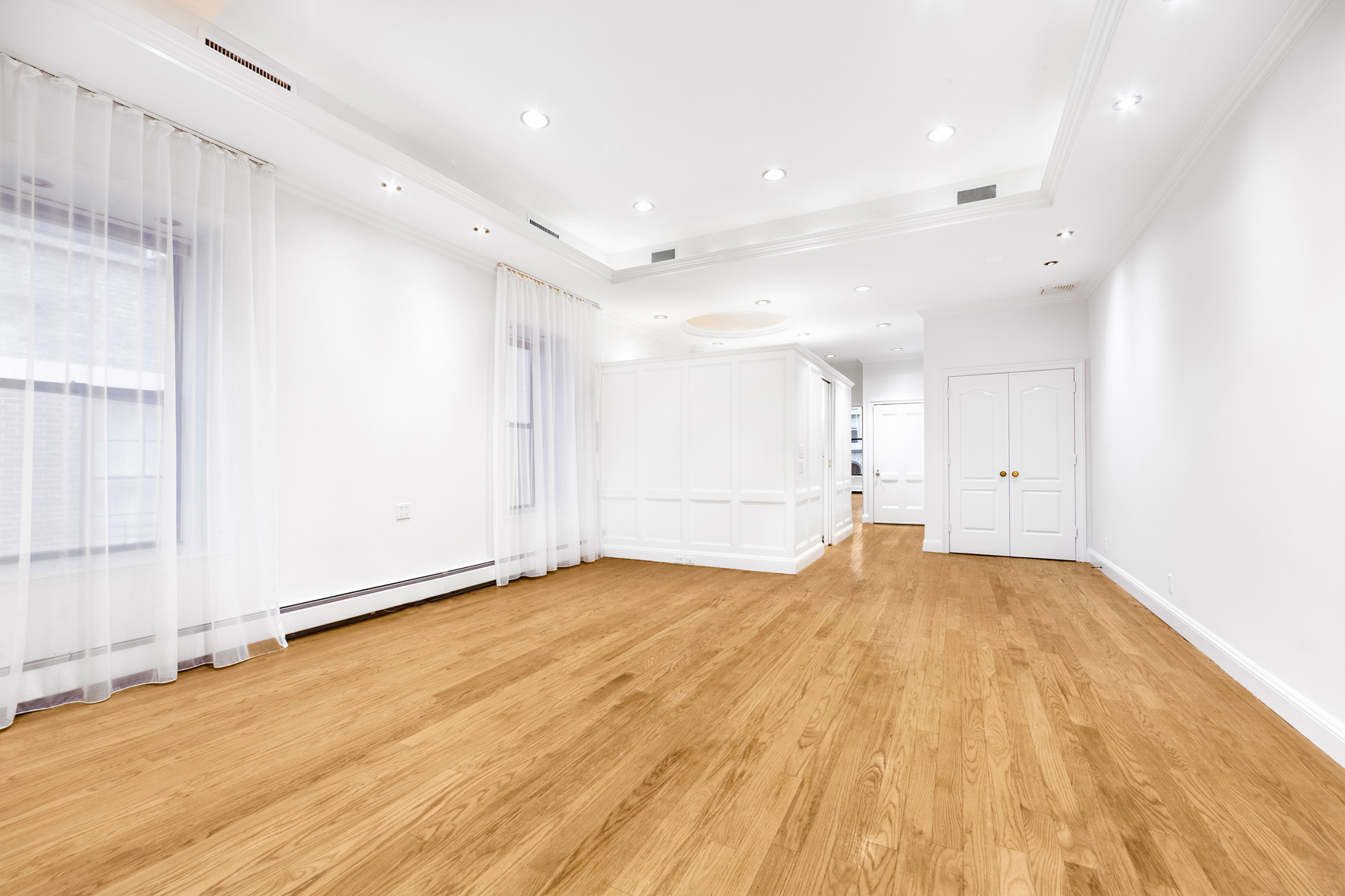 34 East 64th Street, Unit 2 Manhattan, NY 10065 - Photo 3 of 7 a view of an empty room with wooden floor