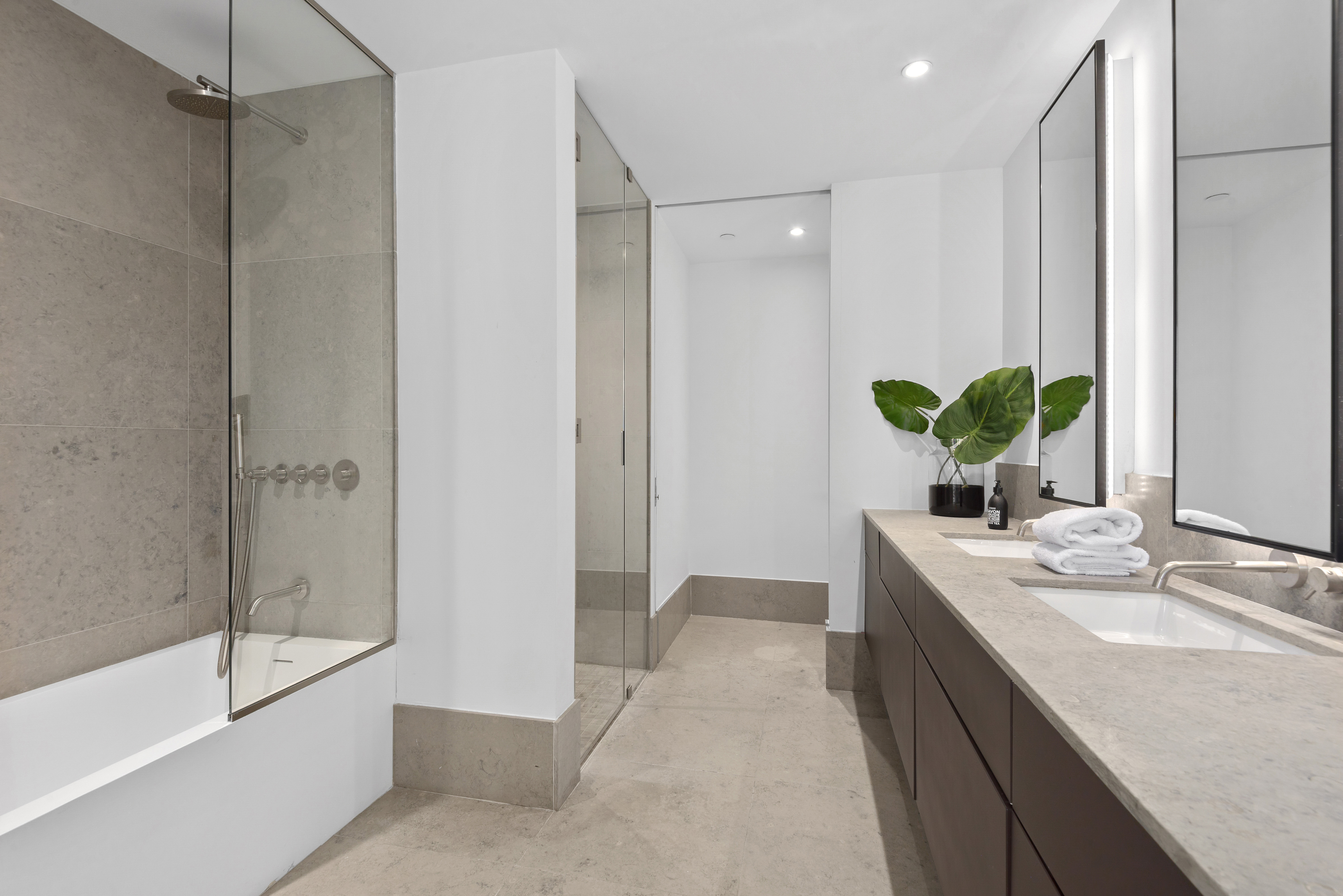 429 Kent Avenue, Unit L32 Brooklyn, NY 11249 - Photo 8 of 15 a bathroom with a tub sink and mirror