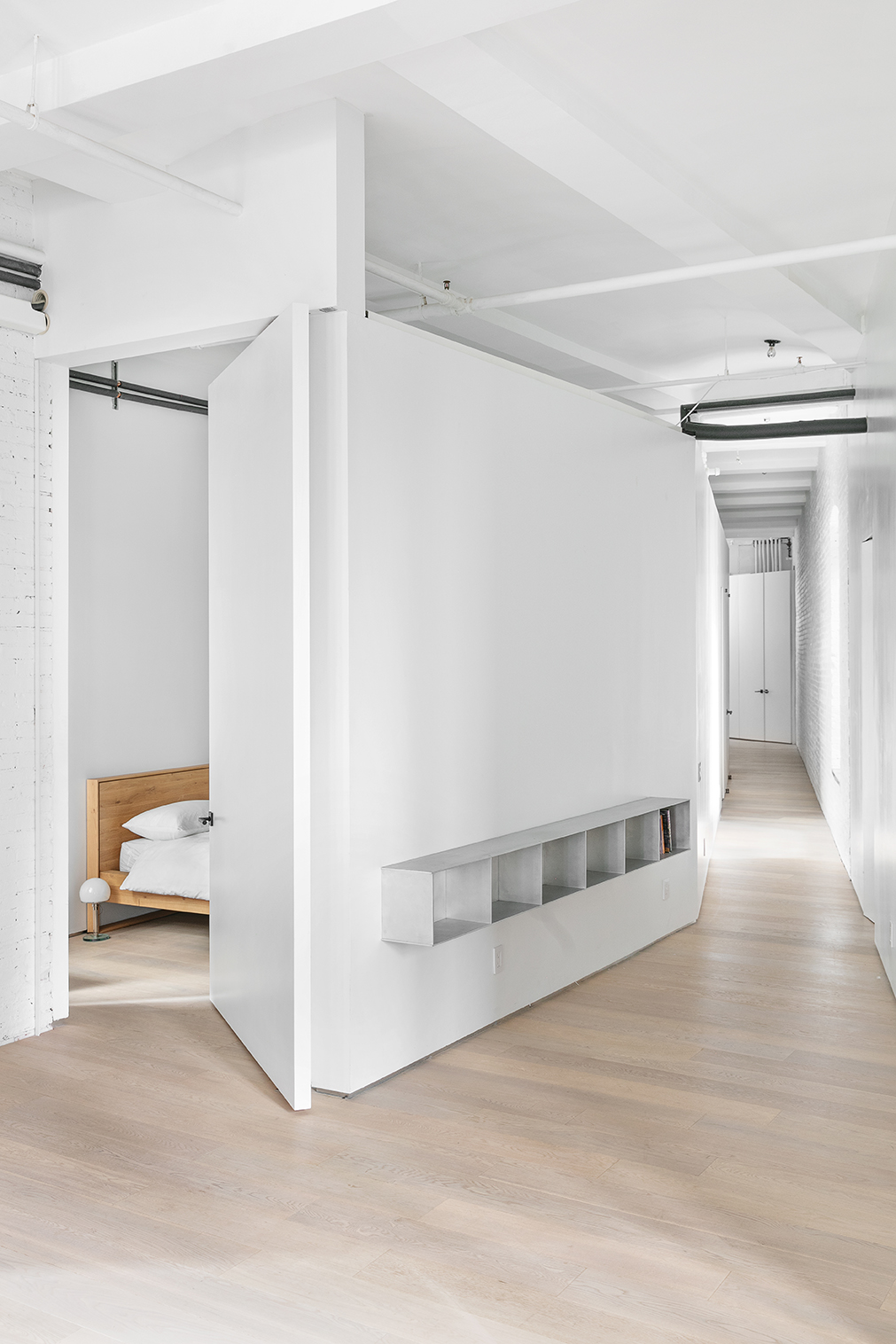 59 4th Avenue, Unit 2B Manhattan, NY 10003 - Photo 5 of 14 a view of a livingroom with wooden floor and a hallway