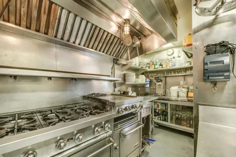 a kitchen with stainless steel appliances granite countertop a stove and a sink