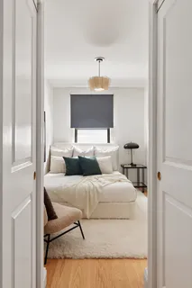 a bedroom with a bed and a lamp