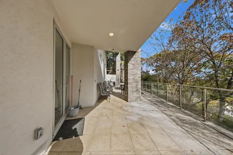 a view of balcony with wooden floor and fence