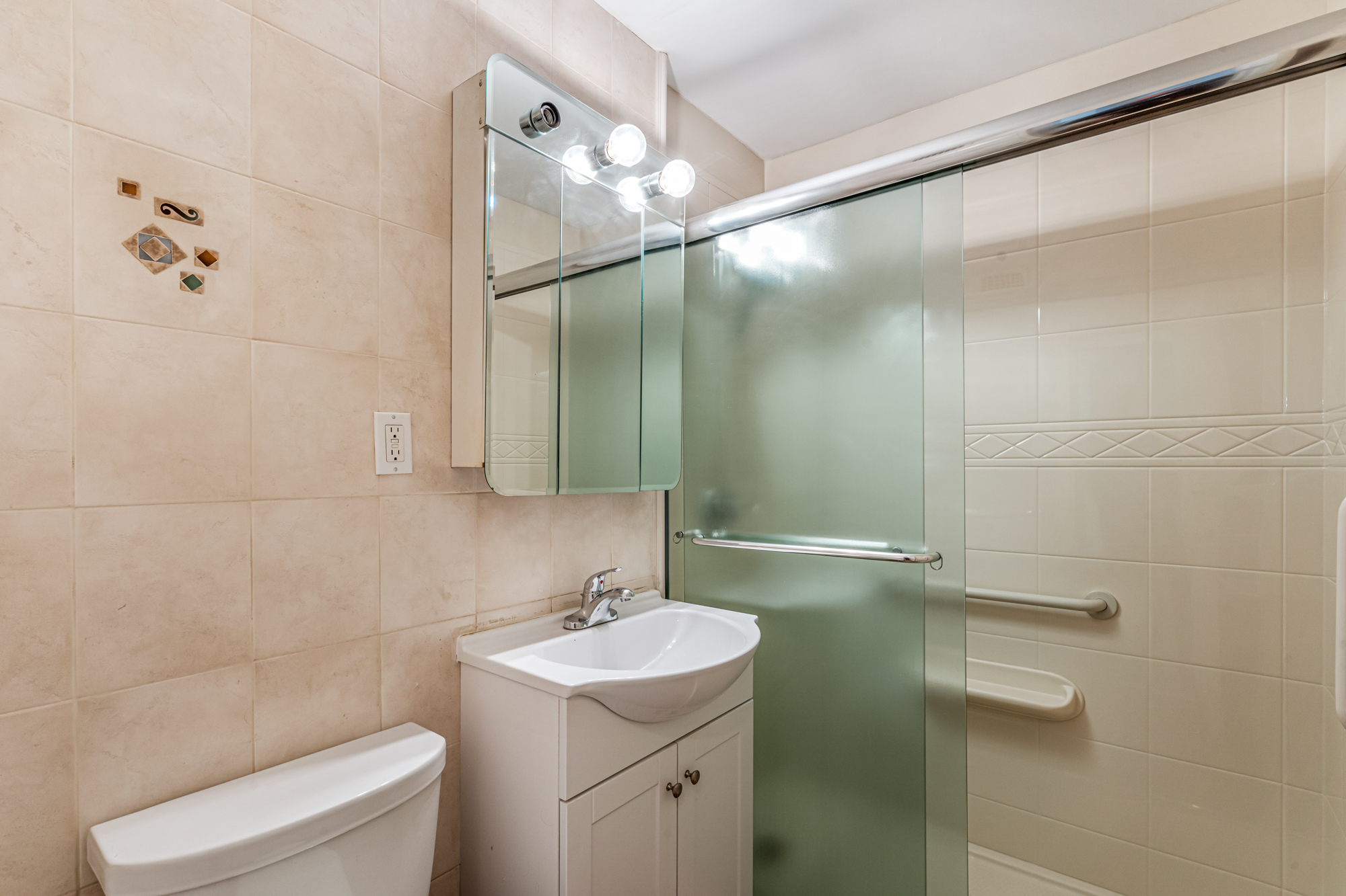 54-44 Little Neck Parkway, Unit 5G Queens, NY 11362 - Photo 13 of 20 a bathroom with a sink toilet and shower