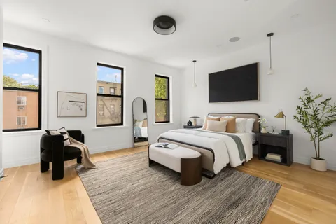 a bedroom with bed and a flat screen tv