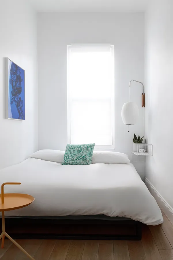 a bedroom with a bed and window