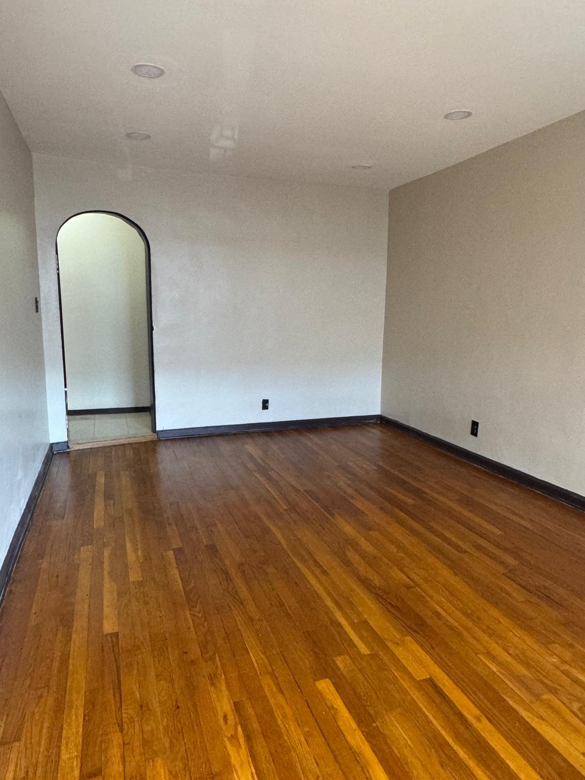647 East 82nd Street, Unit 2 Brooklyn, NY 11236 - Photo 1 of 6 a view of an empty room and wooden floor