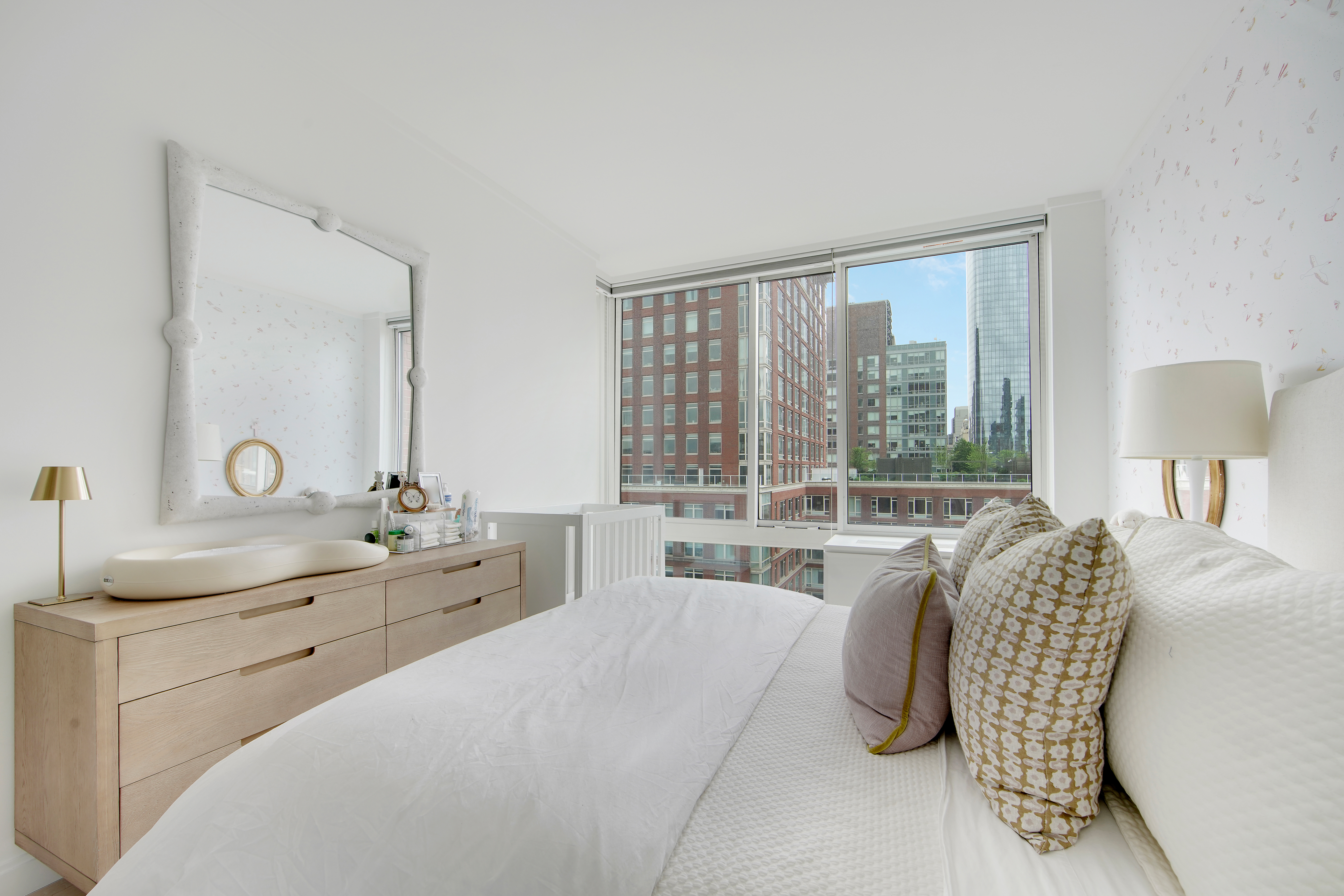 212 Warren Street, Unit 17S Manhattan, NY 10282 - Photo 9 of 15 a spacious bedroom with a bed and large windows