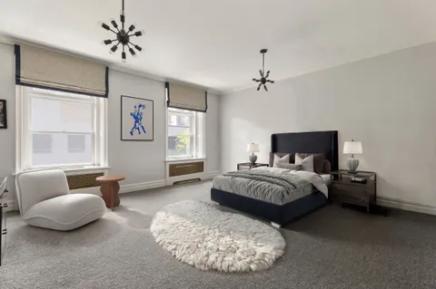 a spacious bedroom with a bed and window