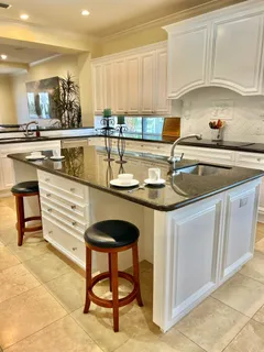 a kitchen with granite countertop a sink and cabinets