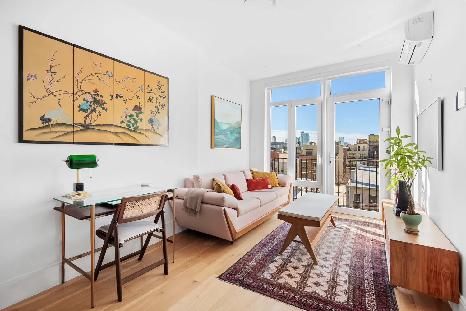 a living room with furniture and a potted plant