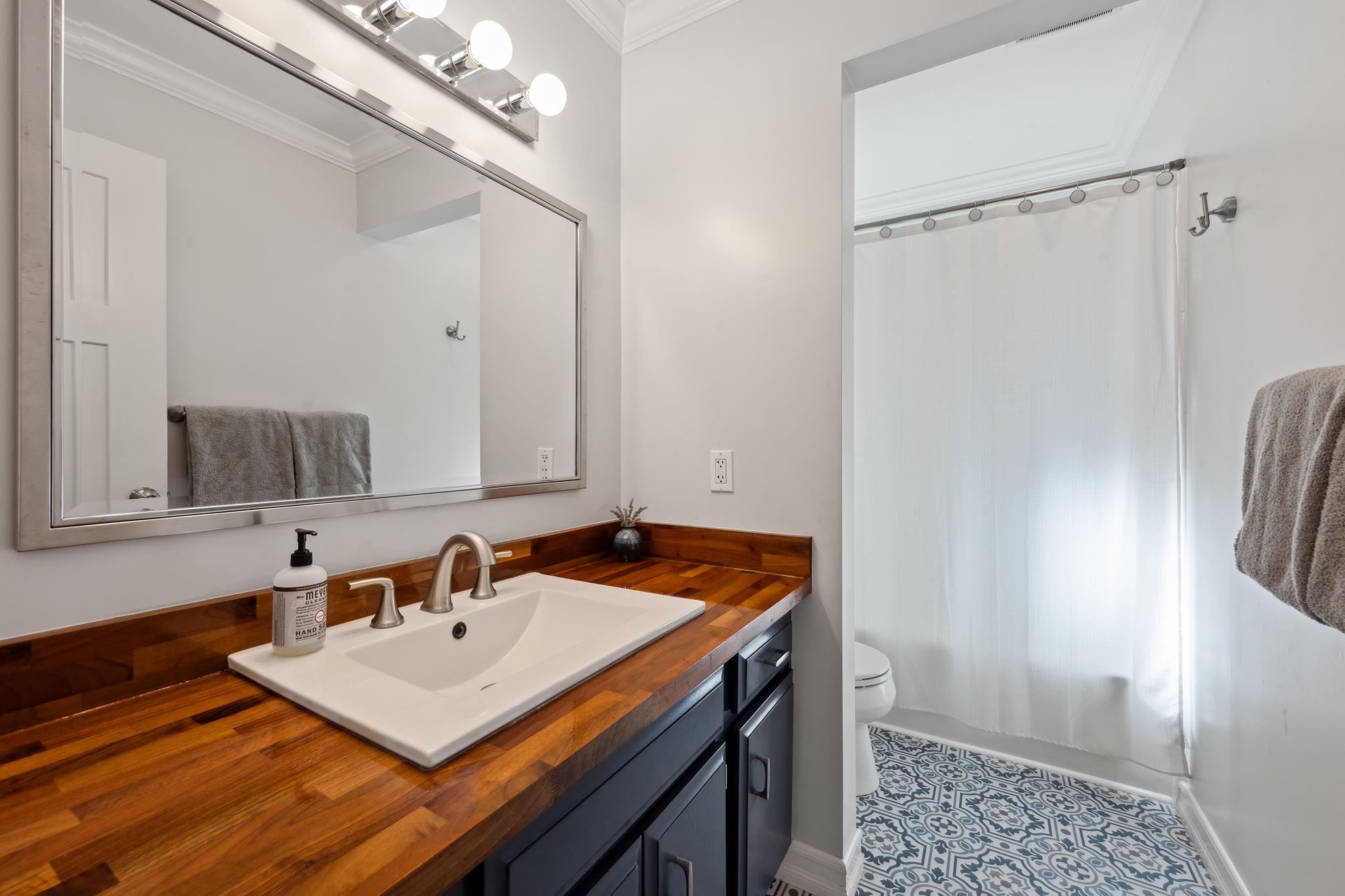 123 Frey Road Santa Rosa, CA 95409 - Photo 33 of 62 a bathroom with a sink a mirror and shower