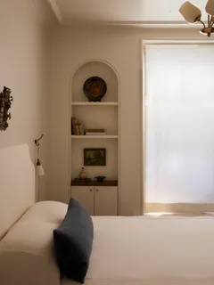 a bedroom with a bed and a fireplace