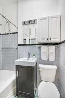 a bathroom with a sink a toilet and bathtub