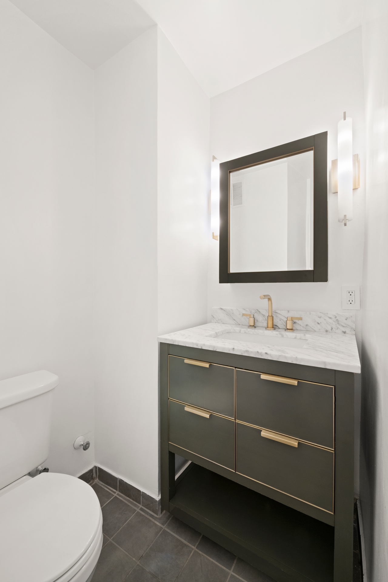 10 West 15th Street, Unit 414 Manhattan, NY 10011 - Photo 11 of 16 a bathroom with a toilet sink and mirror