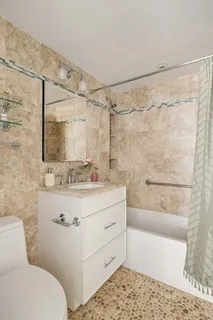 a bathroom with a sink mirror vanity and toilet