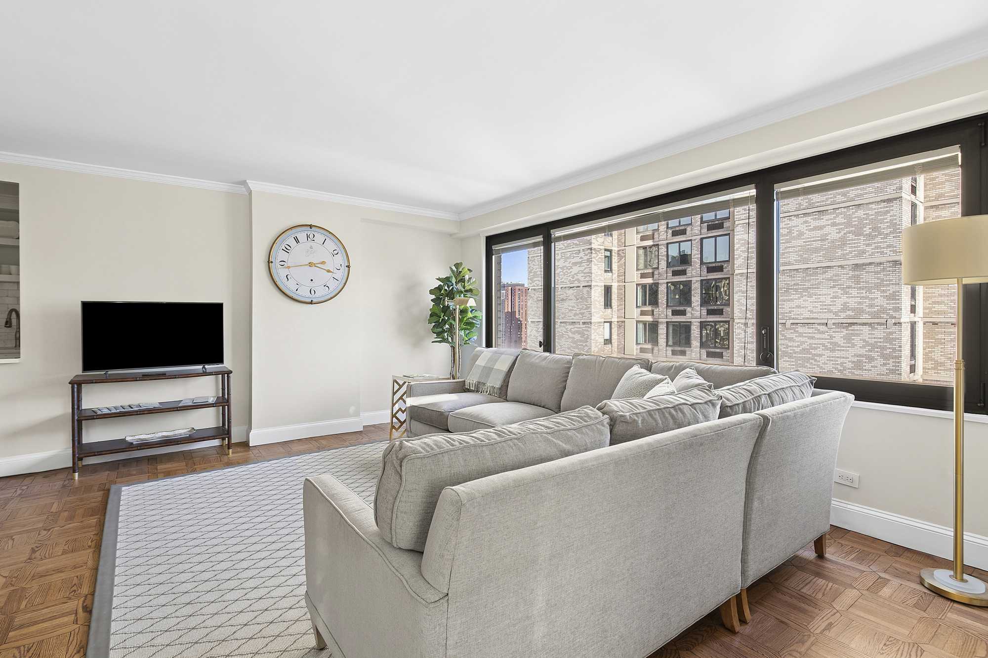 1065 Park Avenue, Unit 27C Manhattan, NY 10128 - Photo 3 of 10 a living room with furniture and a flat screen tv