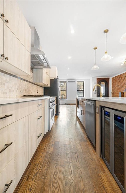 308 Clifton Place Brooklyn, NY 11216 - Photo 5 of 41 a kitchen with stainless steel appliances kitchen island granite countertop a stove top oven a sink a counter space and cabinets