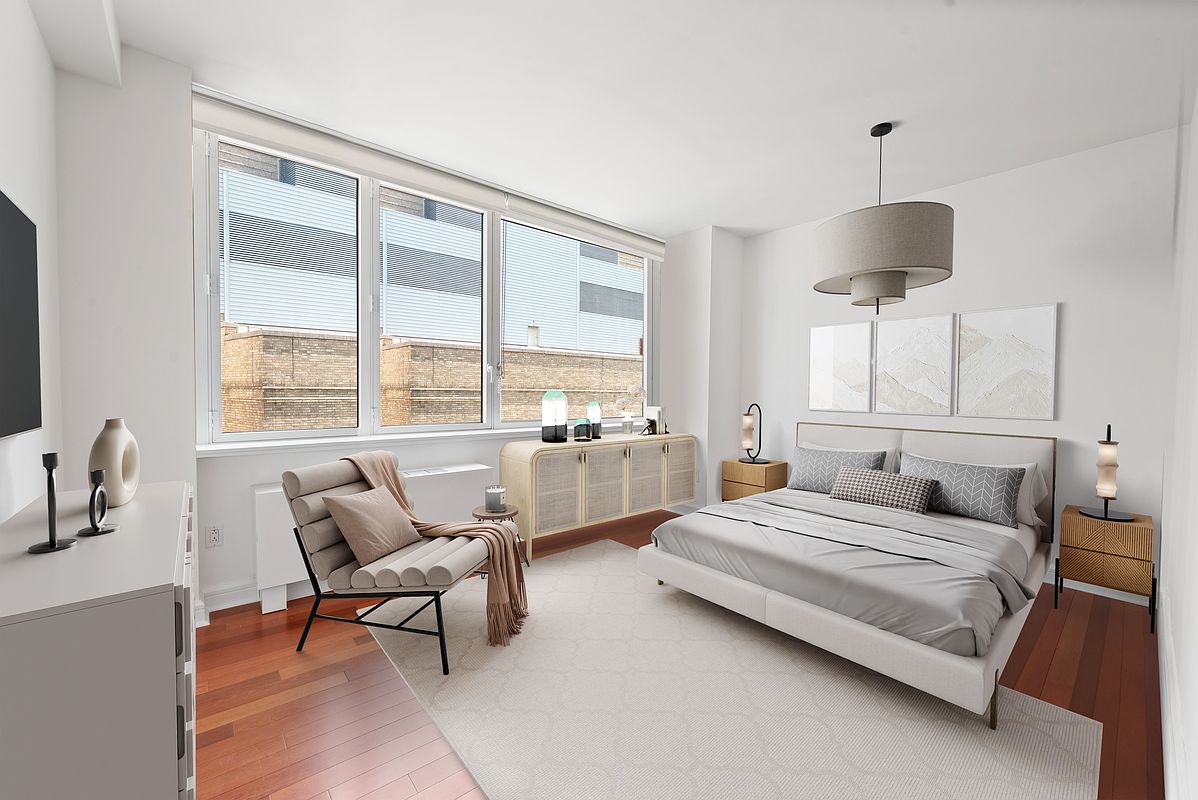 100 Riverside Boulevard, Unit 6C Manhattan, NY 10069 - Photo 2 of 6 a bedroom with a bed and a chandelier