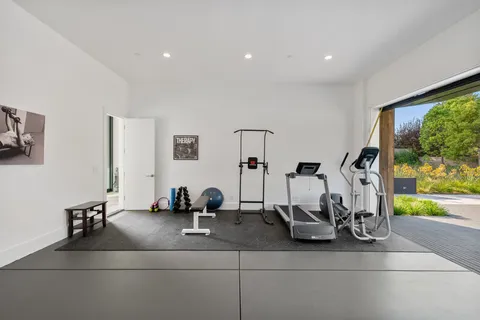 a view of a room with wooden floor and door
