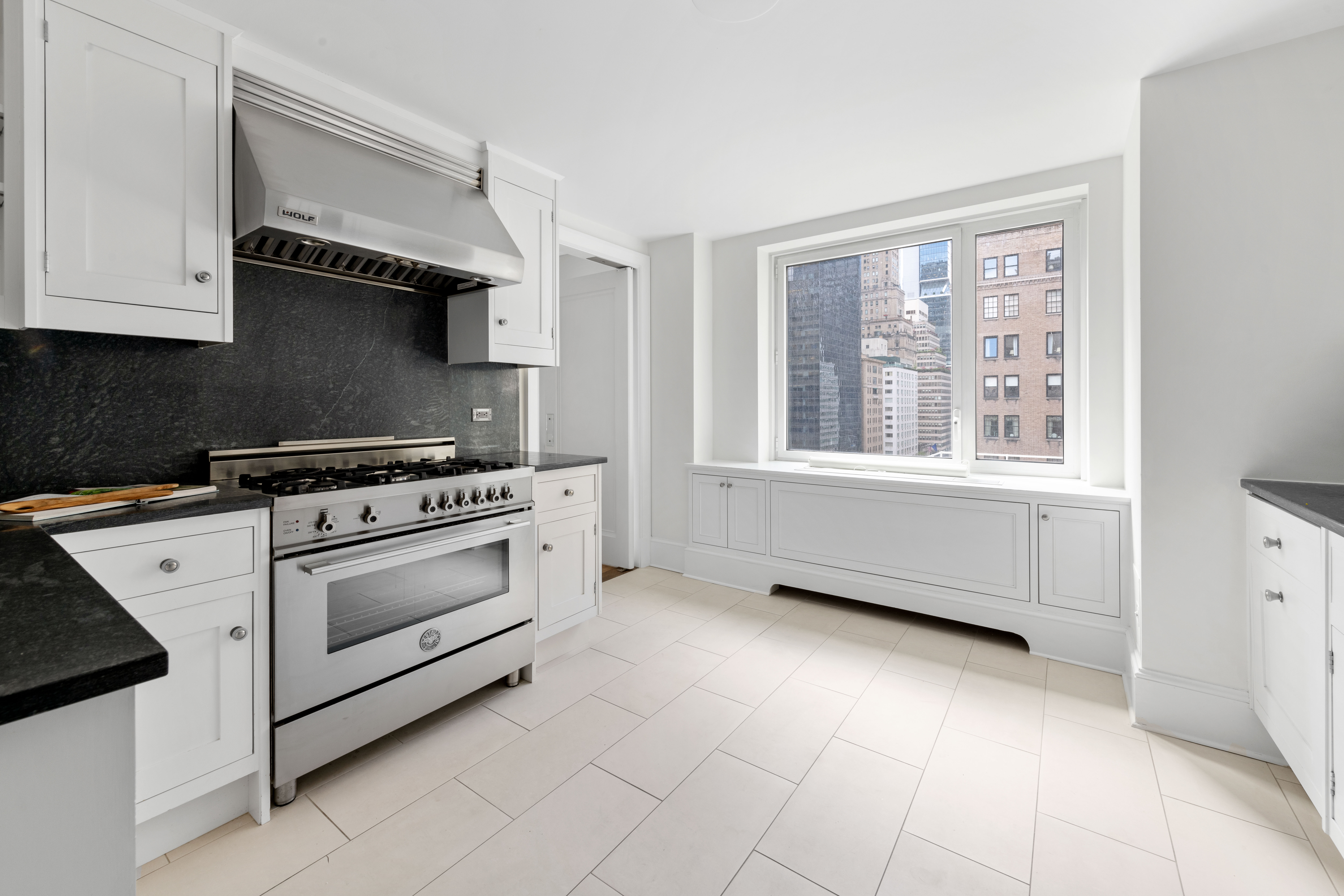 530 Park Avenue, Unit 12A Manhattan, NY 10065 - Photo 10 of 27 a kitchen with a stove and a cabinet
