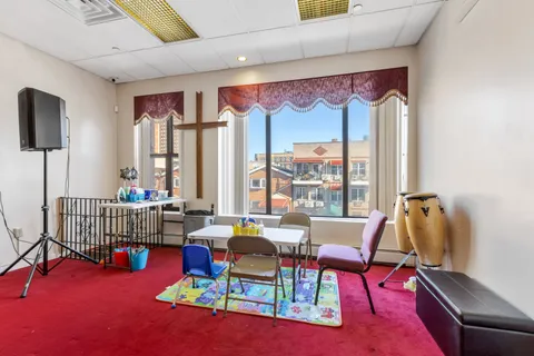 a living room with furniture and a floor to ceiling window