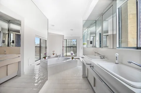 a large white kitchen with a large window