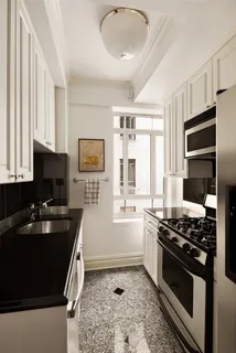 a kitchen with a stove a sink and a microwave