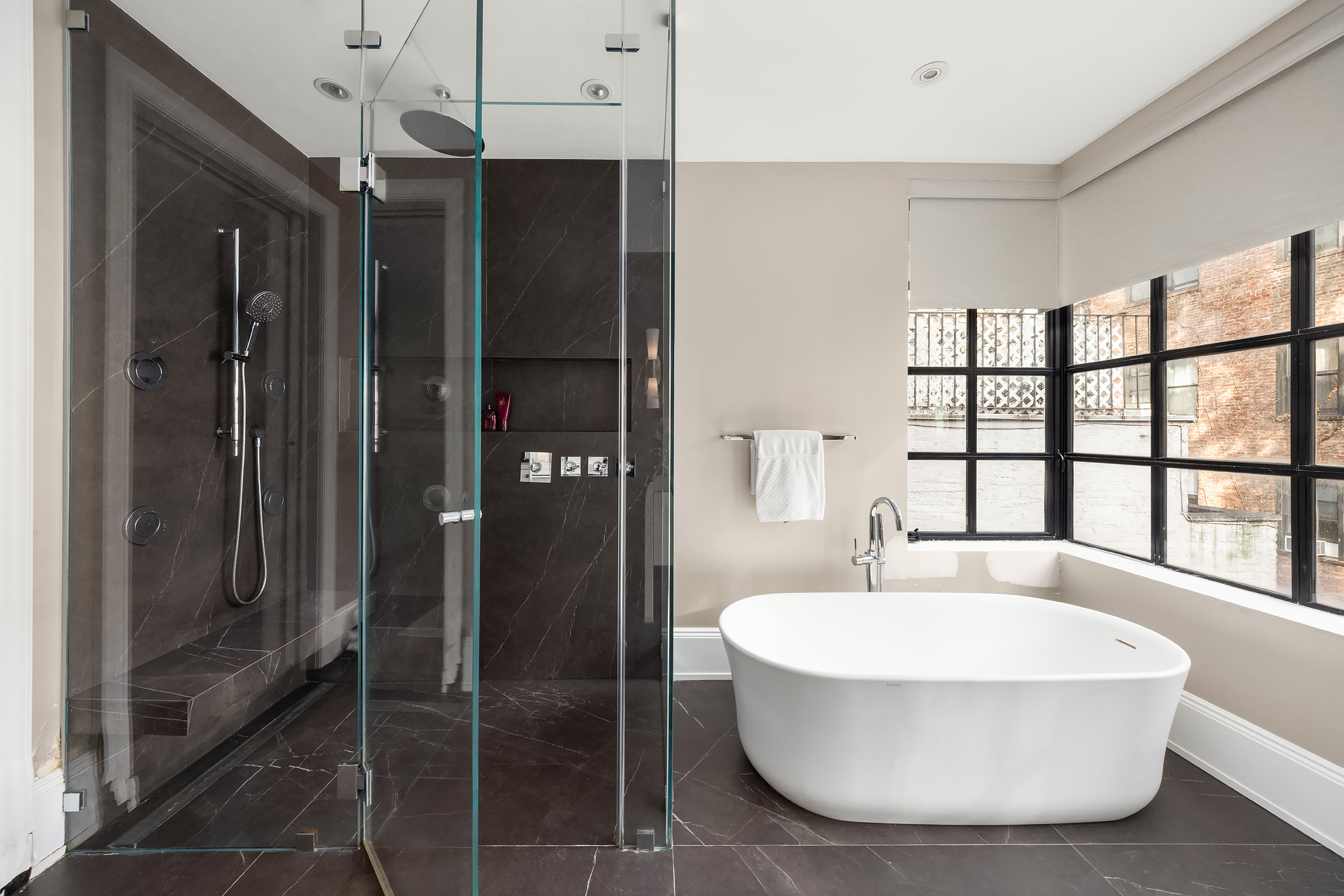 123 East 61st Street Manhattan, NY 10065 - Photo 15 of 31 a bathroom with a bathtub and a shower