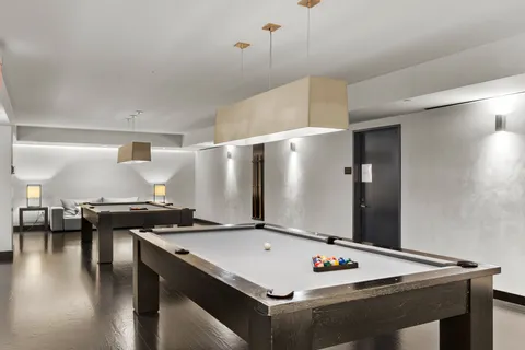 a white kitchen with stainless steel appliances granite countertop a sink a stove and a refrigerator