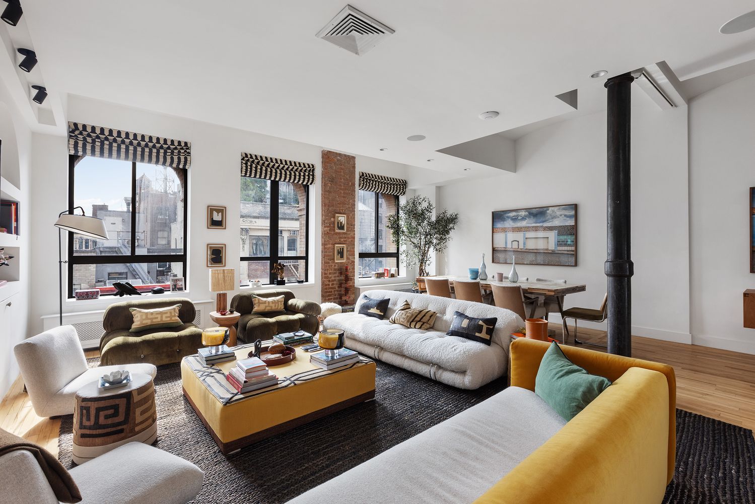 a living room with furniture large window and a table
