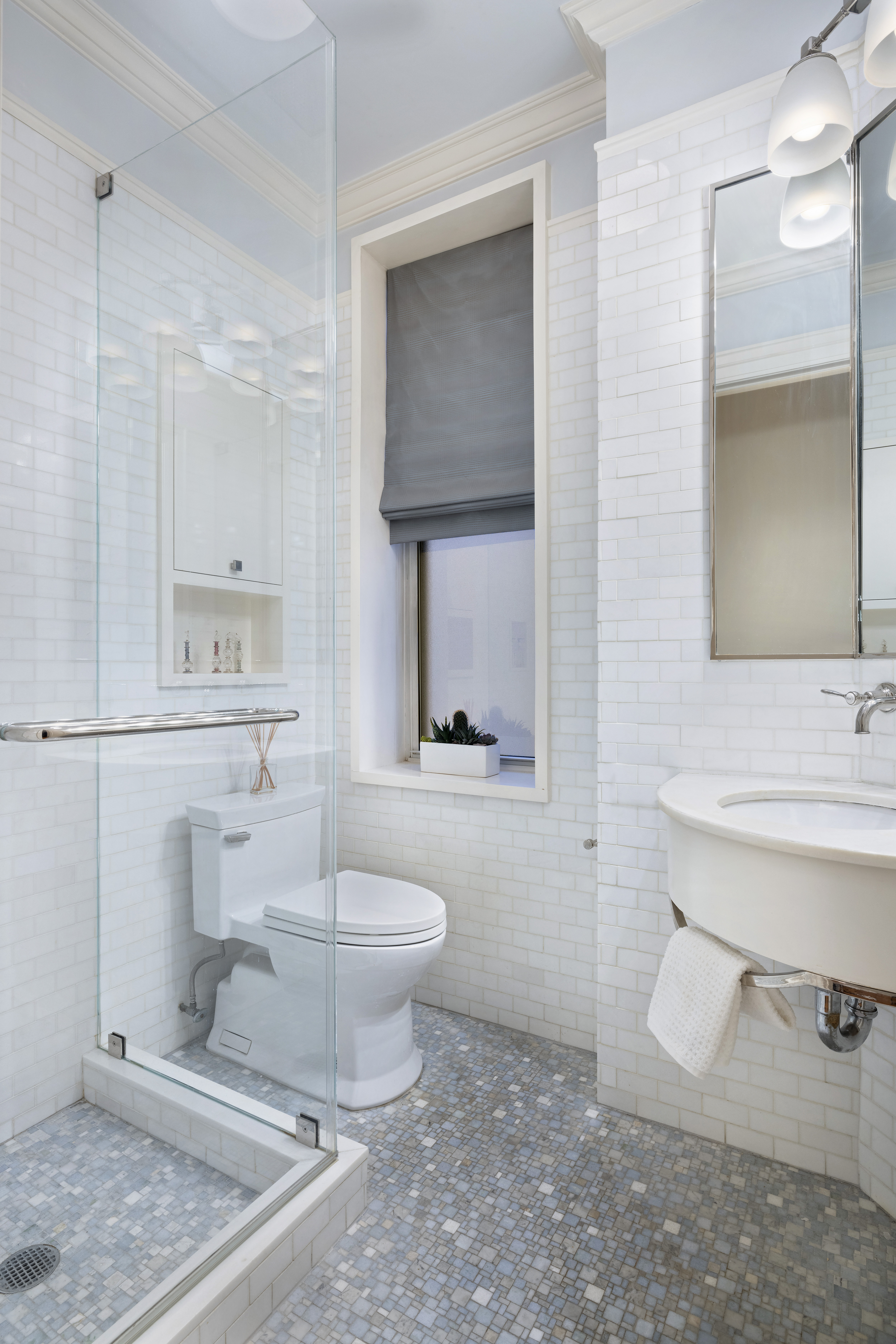 325 West End Avenue, Unit 6AB Manhattan, NY 10023 - Photo 20 of 22 a bathroom with a toilet sink and mirror