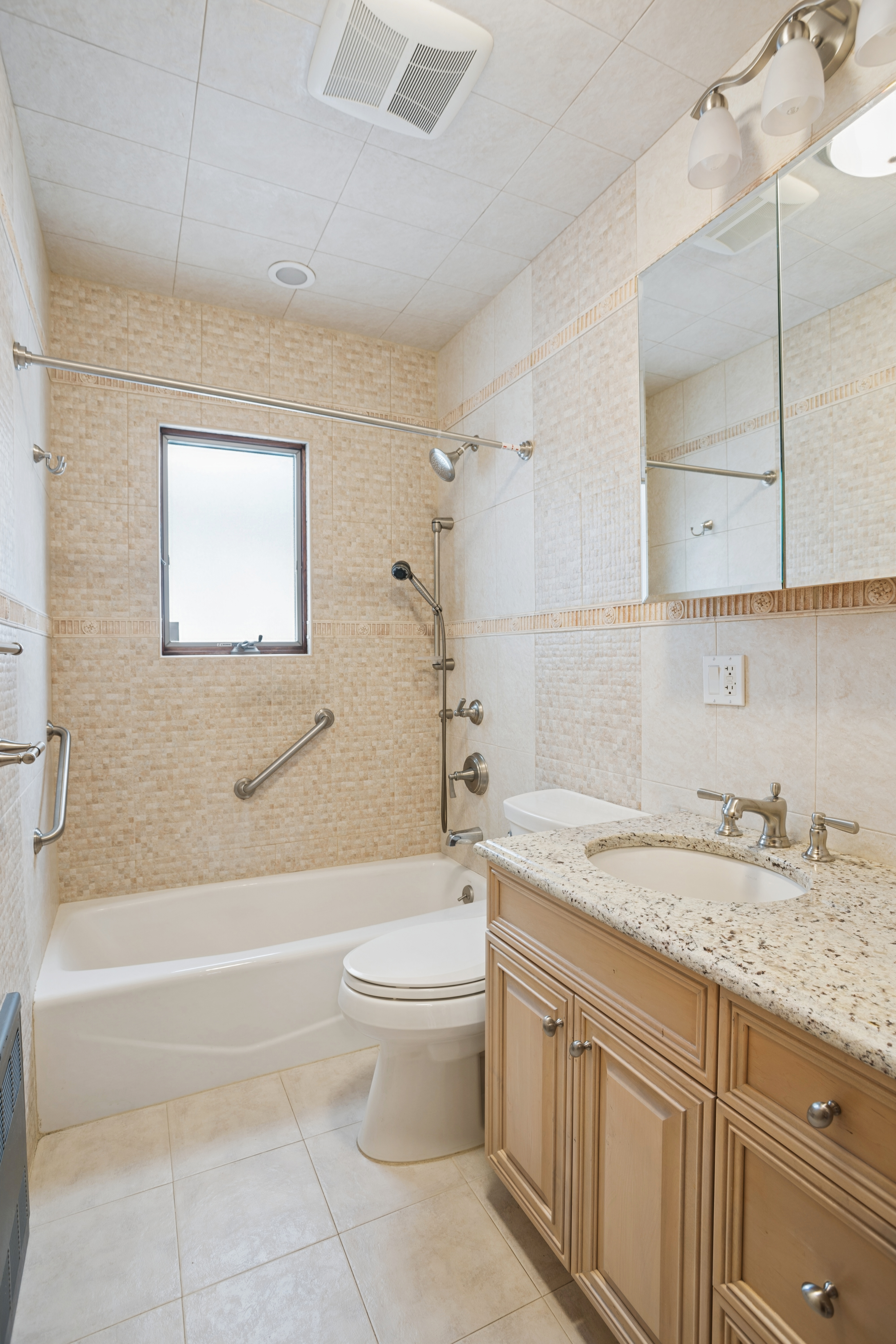 1982 East 23rd Street Brooklyn, NY 11229 - Photo 12 of 16 a bathroom with a granite countertop sink a toilet and bathtub