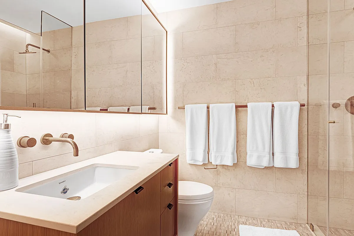 318 West 52nd Street, Unit 3C Manhattan, NY 10019 - Photo 3 of 6 a bathroom with a sink a toilet and shower