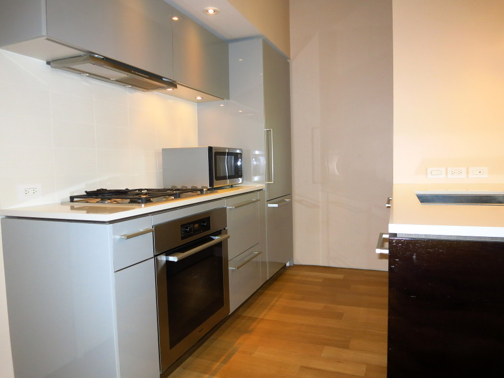 123 3rd Avenue, Unit 12B Manhattan, NY 10003 - Photo 2 of 6 a kitchen with a sink a stove and cabinets