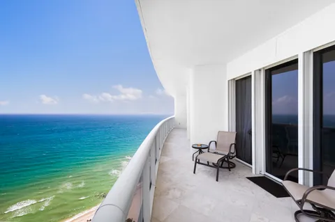a balcony with table and chairs