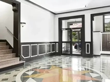 a front view of a building with a garden