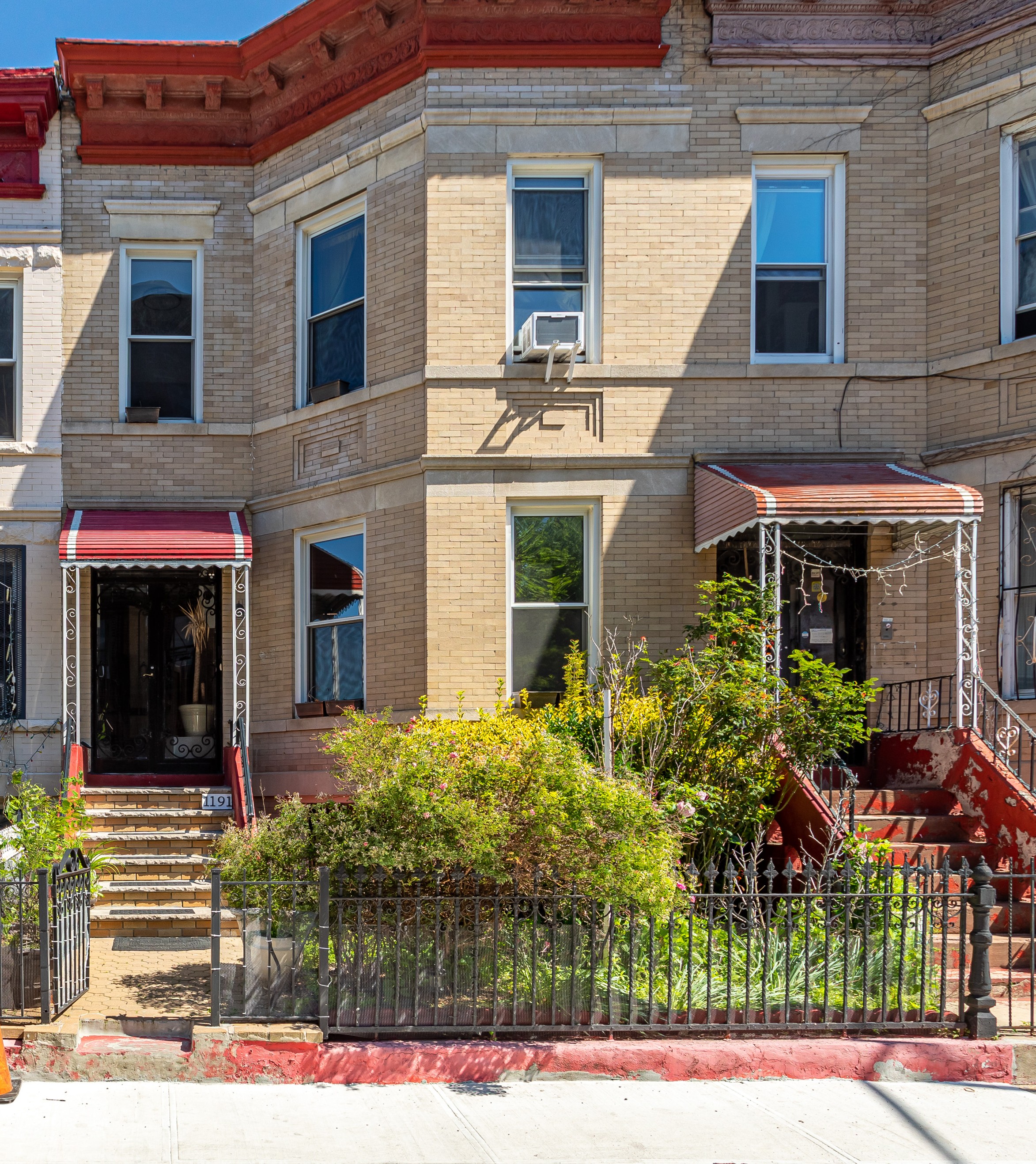 1191 Lincoln Place, Unit 1 Brooklyn, NY 11213 - Photo 10 of 13 a view of a white house with potted plants and a table and chair