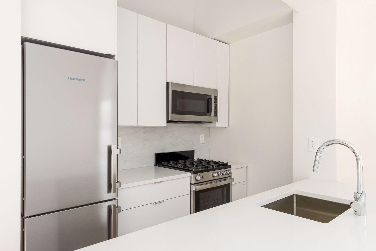 11 Riverside Drive, Unit 17E Manhattan, NY 10023 - Photo 7 of 16 a kitchen with a refrigerator and a sink