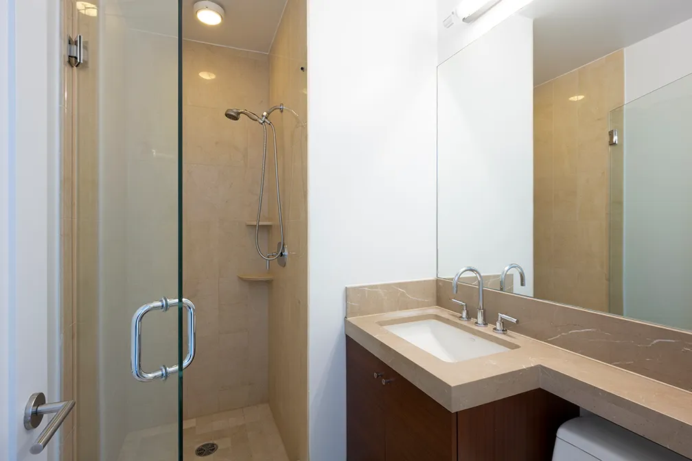 a bathroom with a sink a mirror and shower