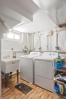 a room with a sink wooden floor and furniture