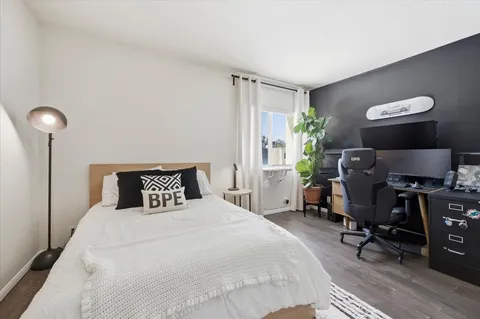 a bedroom with a bed and chair