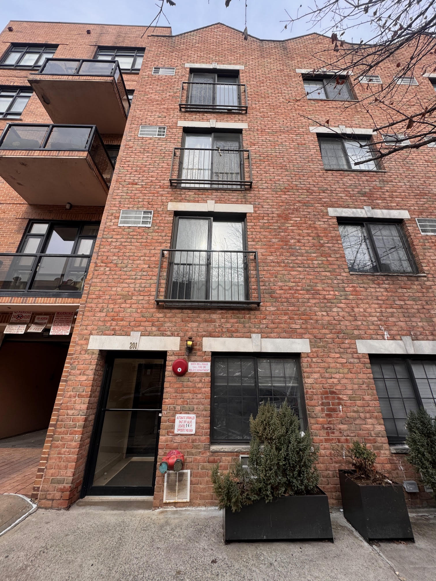 201 Huron Street, Unit 4F Brooklyn, NY 11222 - Photo 11 of 12 front view of a brick house with a small yard